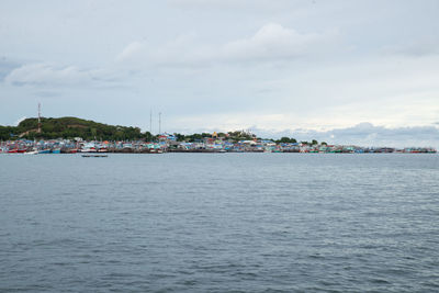 Scenic view of sea against sky in city