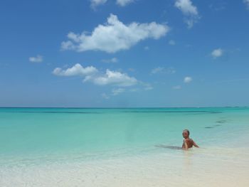 Senior man looking away while relaxing in sea