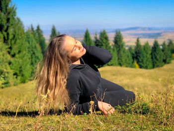Young woman sitting on field