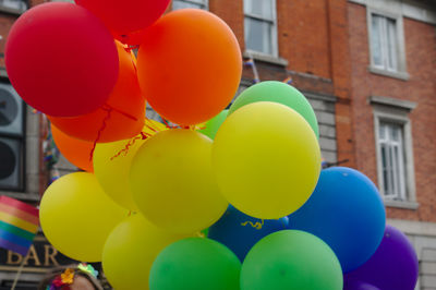 Multi colored balloons against building