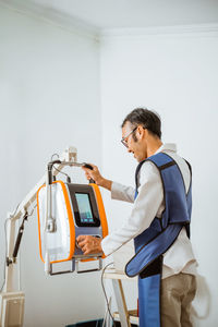 Side view of man working at construction site