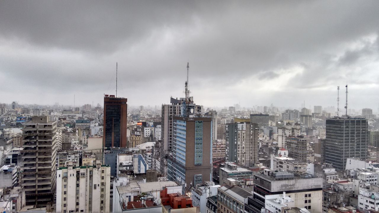 building exterior, architecture, city, built structure, cityscape, sky, cloud - sky, skyscraper, crowded, cloudy, tower, tall - high, residential district, residential building, modern, office building, high angle view, residential structure, weather, cloud