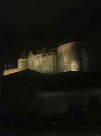 Low angle view of historic building against sky at night