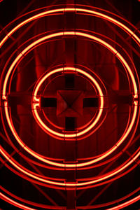 Close-up of illuminated red light against black background