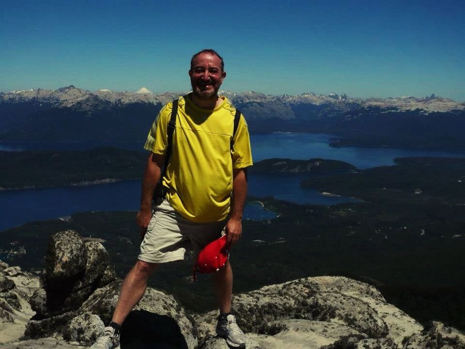 mountain, lifestyles, leisure activity, standing, full length, casual clothing, rock - object, scenics, tranquil scene, tranquility, beauty in nature, mountain range, young men, nature, person, water, young adult, front view