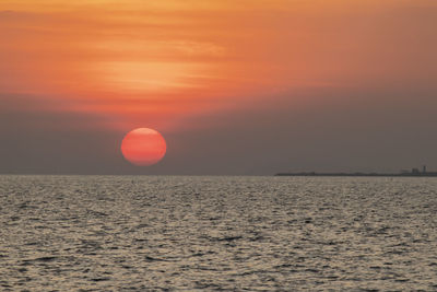 Scenic view of sea against orange sky