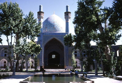 Trees and fountain in front of mosque