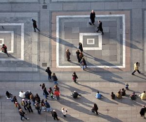 Duomo square seen form atop the terrace of the duomo / cathedral. floor decoration and people. 