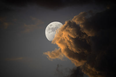 Low angle view of moon in sky at night