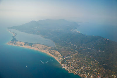 Aerial view of sea and mountains against sky