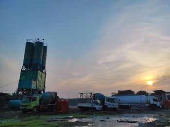 Factory against sky at sunset