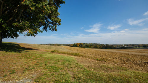 Scenic view of field against cloudy sky