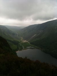 Scenic shot of calm countryside lake against mountain range