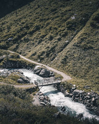 High angle view of stream amidst rocks
