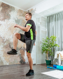 Full length of woman exercising in gym