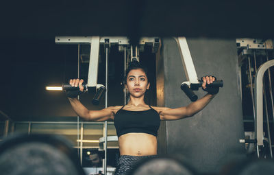 Young woman with arms raised