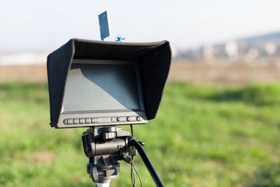 Close-up of equipment on field against sky