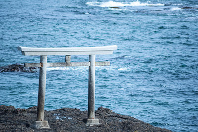 Empty bench by sea