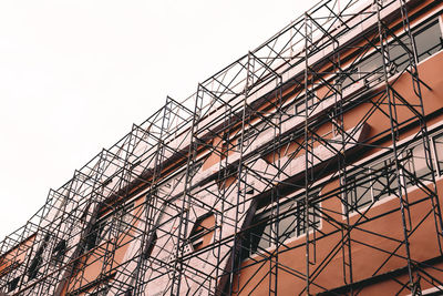 Low angle view of crane against sky