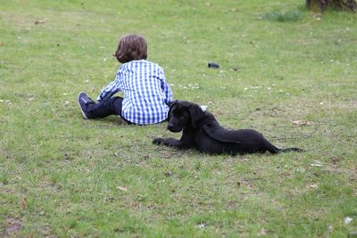 Full length of man relaxing on grassy field