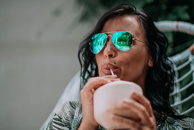 Portrait of a young woman drinking water