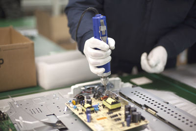 Midsection of man working in factory