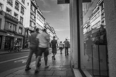 People walking on street in city