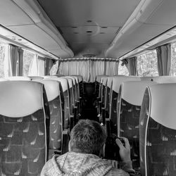 Rear view of man sitting in bus