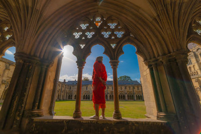 Rear view of man standing at temple in building