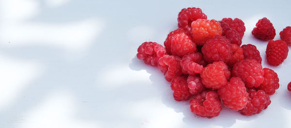 Close-up of strawberries on table against white background