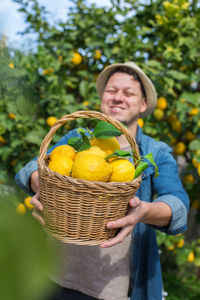 Young woman holding fruits in basket