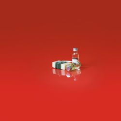 Directly above shot of illuminated light bulb against red background
