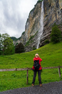 Backpacker in the swiss mountains, staubbach falls.