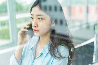 Young woman talking on mobile phone