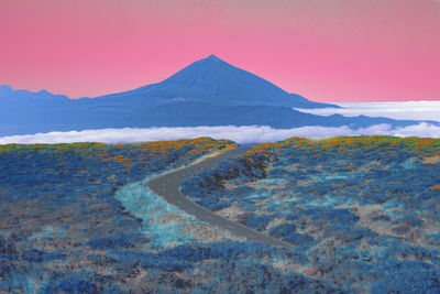 Scenic view of snowcapped mountains against sky during sunset