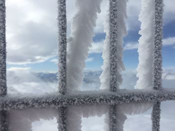 Close-up of frozen ice against sky