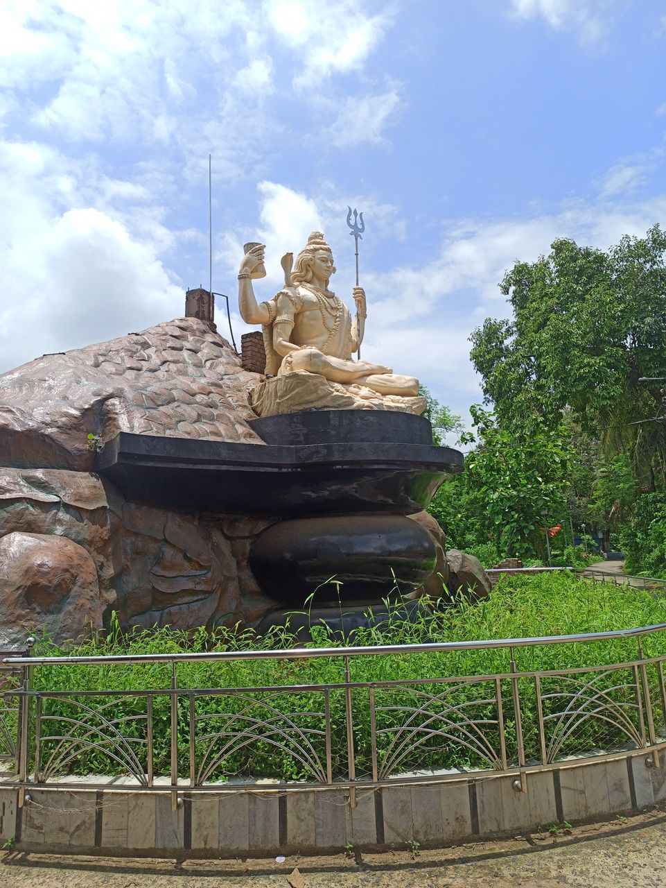 STATUE OF TRADITIONAL WINDMILL AGAINST SKY