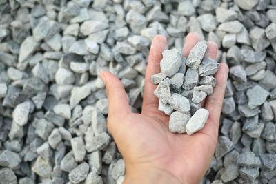 Close-up of hand holding pebbles