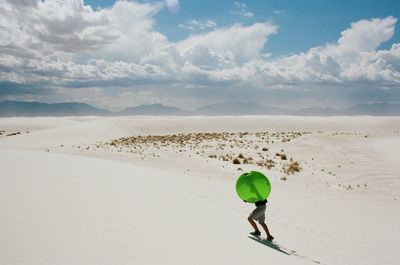 Man on sand at beach against sky