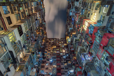 Digital composite image of illuminated buildings against sky at night