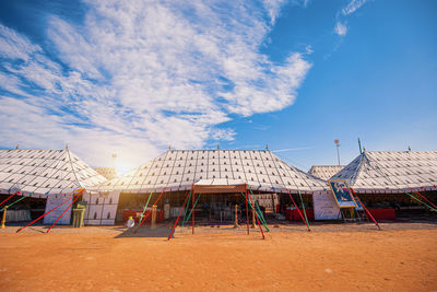 Built structure on beach against blue sky