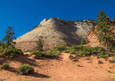 Scenic view of mountains against clear blue sky