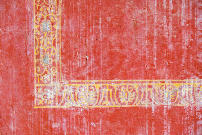 Close-up of text on red wall