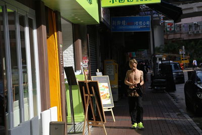 Rear view of man standing in city