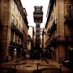 Street amidst buildings in city against sky