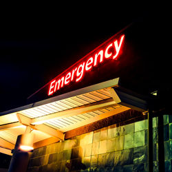 Low angle view of illuminated sign at night