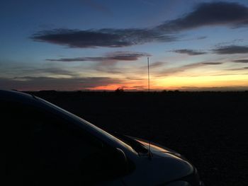 Car on road against sky during sunset