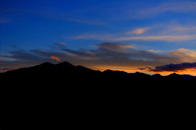 Scenic view of mountains against sky at sunset