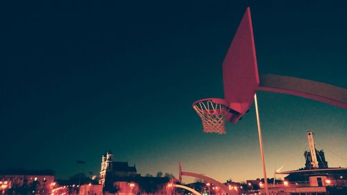 Low angle view of basketball hoop against clear blue sky