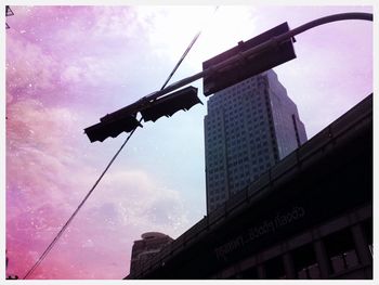 Low angle view of building against cloudy sky